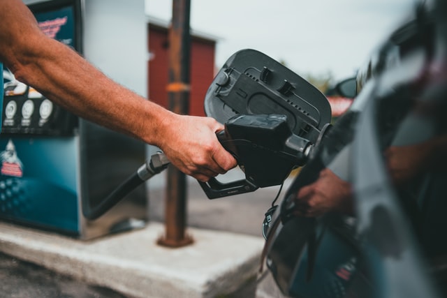 a dude filling up his car's gas tank