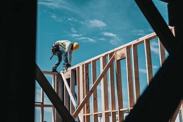 a dude framing a house